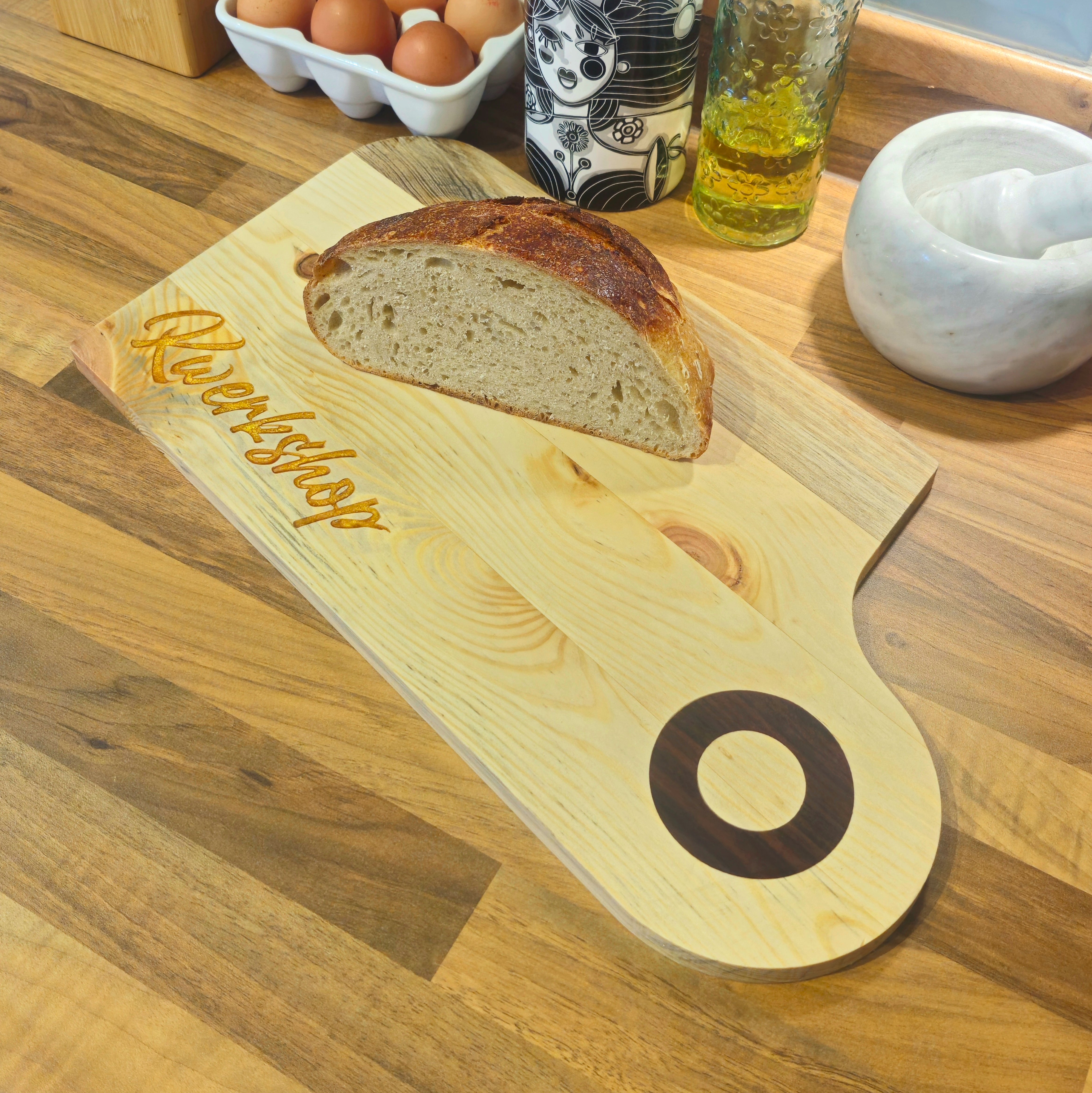 a close up of a wooden chopping board with a piece of bread on top