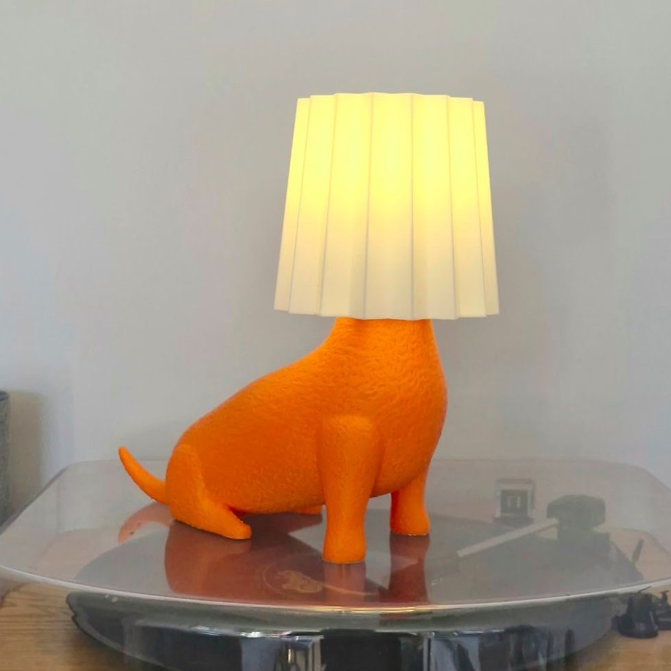 a lamp in the shape of a dog with a shade over its head.