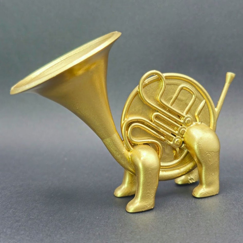 sculpture of a french horn with 4 legs in the position of a dog